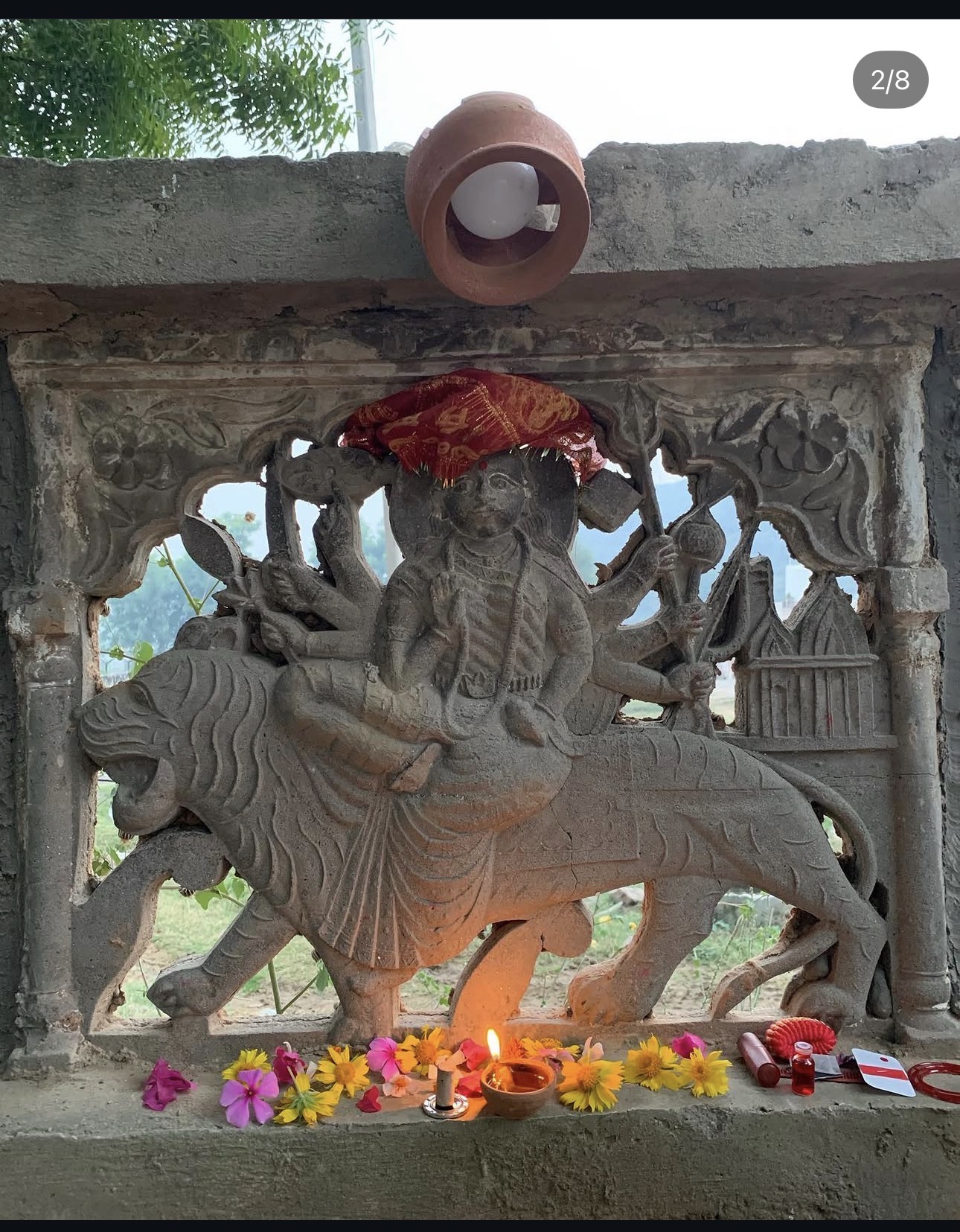 A carved shrine, cleaned and cared for again